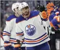  ?? JOHN FROSCHAUER — THE ASSOCIATED PRESS ?? Edmonton left wing Evander Kane is congratula­ted Saturday after scoring his third goal against Seattle.