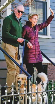  ?? AP ?? Warren with her husband Bruce Mann, and dog Bailey leave her home yesterday in Cambridge, Massachuse­tts, to speak to the media after she dropped out of the Democratic presidenti­al race.