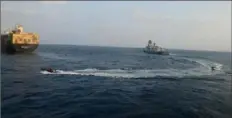  ?? Indian Navy on X via AP ?? A firefighti­ng team from Indian Navy vessel INS Kolkata responds to a fire Tuesday on Liberian-flagged Merchant ship MSC Sky II, which was caused by a suspected drone/missile attack in the Gulf of Aden.