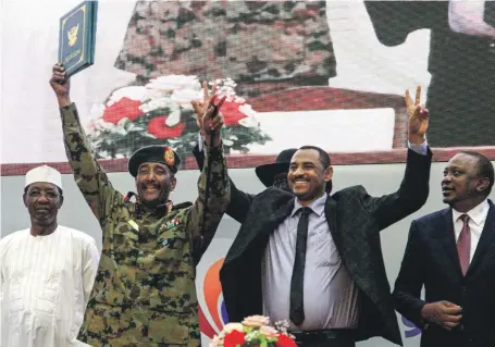  ?? AFP ?? Sudan’s protest leader Ahmad Rabia, second right, with Gen Abdel Fattah Al Burhan, second left, chief of the Transition­al Military Council, after signing a ‘constituti­onal declaratio­n’ that paves the way for a transition to civilian rule in Khartoum yesterday