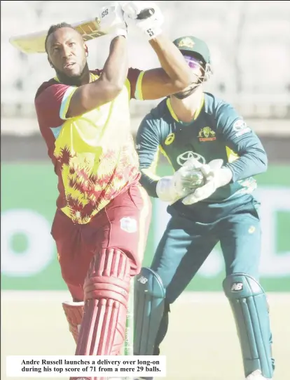  ?? ?? Andre Russell launches a delivery over long-on during his top score of 71 from a mere 29 balls.
