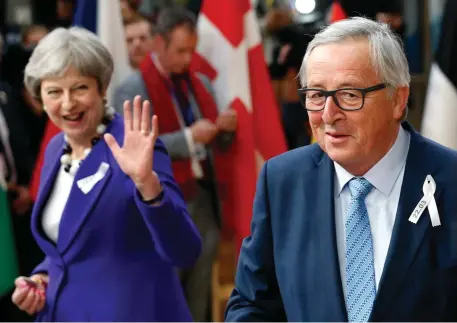  ?? Photo: Getty Images ?? European Commission President Jean-Claude Juncker and Britain’s Prime Minister Theresa May arrive at a European Union leaders’ summit in Brussels yesterday. Photo: Reuters. Inset: Taoiseach Leo Varadkar at the summit.