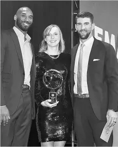  ??  ?? Katie Ledecky (centre) accepts Golden Goggle Award for Female Athlete of the Year from Michael Phelps and Kobe Bryant during the 2017 USA Swimming Golden Goggle Awards at J.W. Marriot at L.A. Live in Los Angeles, California. — AFP photo