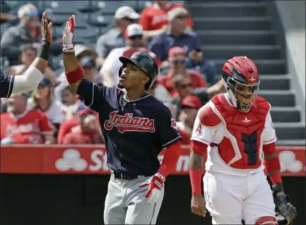  ?? CHRIS CARLSON — THE ASSOCIATED PRESS ?? Francisco Lindor celebrates as Angels catcher Martin Maldonado looks on after his three-run home run during the fifth inning on Sept. 21 in Anaheim, Calif.