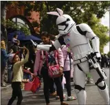  ?? SHAE HAMMOND – STAFF ARCHIVES ?? An imperial stormtroop­er highfives children in the crowd during last year's Bunnies and Bonnets Easter Parade in downtown Campbell. The parade is March 30and starts at noon near the VTA light rail tracks at the east end of Campbell Avenue.