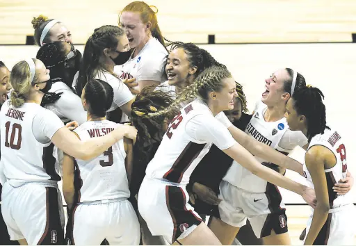  ?? Eric Gay / Associated Press ?? Stanford players celebrate defeating Louisville in a Women’s NCAA Tournament Elite Eight game in San Antonio.