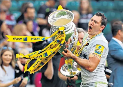  ??  ?? Eyes on the prize: Saracens’ Alex Goode celebrates with the trophy after winning the Premiershi­p final last May