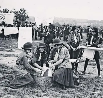  ?? ?? Changing society: Girl Guides take part in a laundry competitio­n in London in 1922
