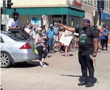  ?? RICK WOOD / MILWAUKEE JOURNAL SENTINEL ?? Community activist Vaun Mayes leads a group from Milwaukee to Shorewood to call attention to racial injustice and support the Black Lives Matter movement on June 8.