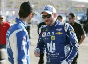  ?? RALPH FRESO — THE ASSOCIATED PRESS ?? Dale Earnhardt Jr., right, talks with Trevor Bayne in the garage area before practice for the NASCAR Cup Series auto race at Phoenix Internatio­nal Raceway, Saturday in Avondale, Ariz.