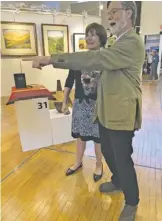  ?? COURTESY PHOTO ?? RAAC President Matthew Black and Art Tour Chair Heather Wicke enjoy the myriad exhibits.