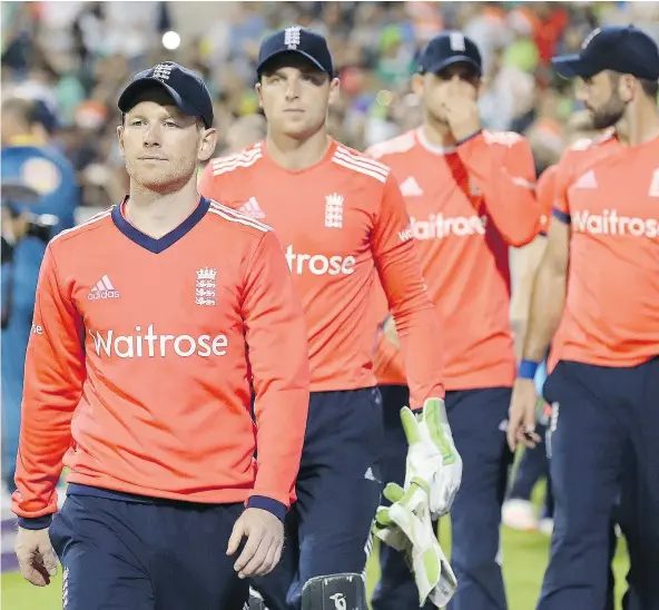  ?? — THE ASSOCIATED PRESS FILES ?? England’s Eoin Morgan leads his players off the pitch after losing against Pakistan, after a Twenty20 match at Old Trafford, in Manchester on Sept. 7. Morgan’s decision not to travel to Dhaka for an upcoming tour could cost him his job.