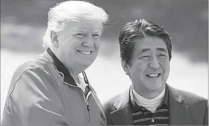  ?? -AP ?? US President Donald Trump and Japanese Prime Minister smile in a golf club during Trump's visit to Japan.