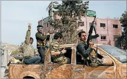  ?? NAZEER AL-KHATIB/GETTY-AFP ?? Turkish-backed Syrian rebels celebrate the seizure of Afrin from Kurdish forces.