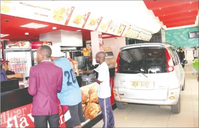  ??  ?? A fastfoods outlet in the capital yesterday had an unusual shopper when a motorist lost control of his vehicle and crashed into the restaurant, sending shoppers scurrying for cover. There were no reports of injuries. — (Picture by John Manzongo)