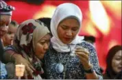  ?? ANNICE LYN — THE ASSOCIATED PRESS ?? Norazlinda Ayub, left, and Intan Maizura Othaman, wife of an air crew member of Malaysia Airlines Flight 370, embrace each other during the Day of Remembranc­e for MH370 event in Kuala Lumpur, Malaysia, Sunday.