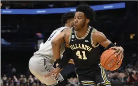  ?? NICK WASS — THE ASSOCIATED PRESS ?? Villanova’s Saddiq Bey (41), dribbling against Georgetown’s Jagan Mosely, is the Big 5 Player of the Year.