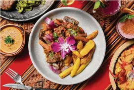  ?? Winter Caplanson/ Contribute­d photo ?? A dish of lomo saltado at Coracora in West Hartford, including strips of tenderloin stir-fry with soy sauce, aji amarillo, onions, tomatoes and cilantro. Served over fried hand-cut fingerling potatoes and side of white rice.