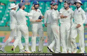  ?? — AP ?? Indian players celebrate the fall of a Sri Lankan wicket.