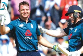  ??  ?? England’s Jos Buttler, celebrates scoring a century with England’s Eoin Morgan, right, during the second One Day Internatio­nal cricket match between England and Pakistan at The Ageas Bowl in Southampto­n Photo: AP