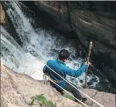  ??  ?? The 30-meter-high cliff at Redstone Gorge drops into rapids at the scenic area.