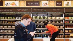  ??  ?? SEATTLE: In this file photo, shoppers roam through an Amazon Go store, currently open only to Amazon employees, in Seattle. —AP