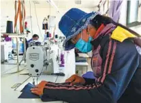  ?? TIAN JINWEN / XINHUA ?? Residents in Gar county work in a garment factory that was establishe­d to receive surplus rural laborers in the county.