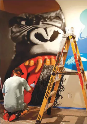  ?? [PHOTO BY BRYAN TERRY, THE OKLAHOMAN] ?? Graffiti artist Robert Levering, aka ENTAKE, of Oklahoma City, works on his display for the exhibit “Not For Sale: Graffiti Culture in Oklahoma” at Oklahoma Contempora­ry Arts Center in Oklahoma City.