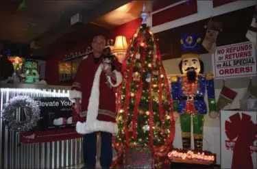  ?? BRIANA CONTRERAS - THE MORNING JOURNAL ?? Mitch Witherell, owner of DiFrancesc­o Garage Doors &amp; Electric Openers, 3300 Oberlin Ave. in Lorain, has become known as “Mr. Christmas” because of the large displays he puts up in his shop during the holidays.