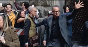  ?? Picture: REUTERS ?? GREETING FANS: Tom Hanks says his family dines out on the story.