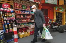  ?? File/AP ?? An elderly man shops at a grocery store in Tehran, Iran.