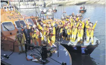  ??  ?? A BEACON OF HOPE: The RNLB the Alan Massey arrives into Baltimore, top, and above, members of the lifeboat service welcome the Alan Massey and say farewell to Hilda Jarrett