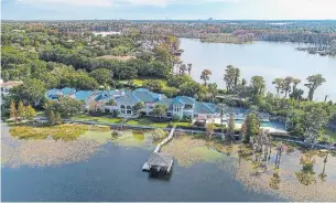  ??  ?? The 12-bedroom, 11-bathroom home occupies most of the 700-foot frontage of Lake Butler.