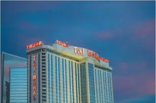  ?? (Mark Makela/Reuters) ?? THE TRUMP Taj Mahal Casino is illuminate­d at dusk in Atlantic City, New Jersey.