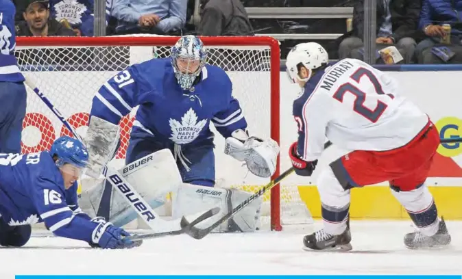  ??  ?? TORONTO: Ryan Murray #27 of the Columbus Blue Jackets looks to get a puck at Frederik Andersen #31 of the Toronto Maple Leafs during an NHL game at Scotiabank Arena in Toronto, Ontario, Canada. — AFP