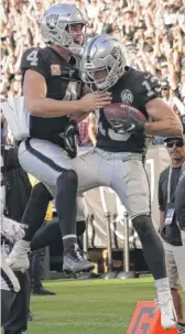  ?? D. ROSS CAMERON/AP ?? Raiders wide receiver Hunter Renfrow (13) celebrates with quarterbac­k Derek Carr after they connected for the go-ahead TD in the fourth quarter.