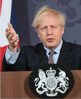  ?? AP, LEFT; GETTY IMAGES, ABOVE ?? ‘TAKEN BACK CONTROL’: Prime Minister Boris Johnson holds a press conference on reaching a Brexit trade deal in Downing Street on Thursday.