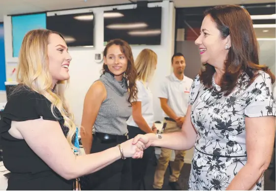  ?? Picture: RICHARD GOSLING ?? Premier Annastacia Palaszczuk meets GOLDOC staffer Casey Irwin at the organisati­on’s Ashmore headquarte­rs yesterday.
