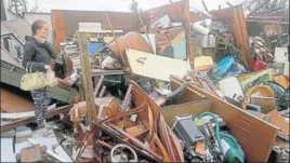  ?? AP ?? Haley Nelson inspects damages to her family properties in Panama City hit by Hurricane Michael.