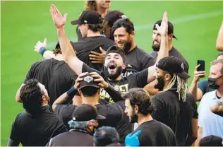  ?? SEAN M. HAFFEY GETTY IMAGES ?? Padres players celebrate clinching a playoff berth Sept. 20 after beating Seattle at Petco Park.