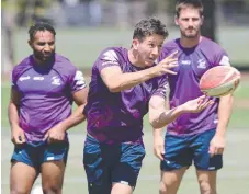  ?? Picture: David Crosling/AAP ?? FITTING IN: Cooper Johns offloads during a Storm training session in Melbourne,