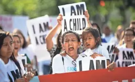  ?? ?? People protest the separation of immigrant families with a march in Washington, D.C., in 2018. Advocates believe at least 500 and up to 1,000 children remain separated from their families because of the policy.