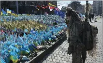  ?? GENYA SAVILOV – GETTY IMAGES ?? A Ukrainian servicewom­an stands in front of a makeshift memorial for fallen Ukrainian soldiers at the Independen­ce Square on the Internatio­nal Women's Day in Kyiv on Friday.