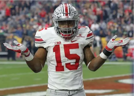  ?? ROSS D. FRANKLIN/THE ASSOCIATED PRESS ?? Ohio State running back Ezekiel Elliott rubs it in just a bit as he celebrates his fourth touchdown against Notre Dame in the Fiesta Bowl on Friday.