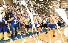  ?? Photo courtesy of John Brown University ?? John Brown students throw toilet paper after Luke Harper’s 3-point shot 14 seconds into Saturday’s season-opener against Ecclesia in the annual Toilet Paper Game at Bill George Arena.