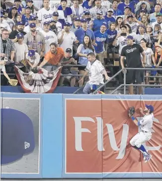  ?? Robert Gauthier Los Angeles Times ?? CENTER FIELDER Chris Taylor bangs into the wall, but he runs out of room in an attempt to catch Marwin Gonzalez’s home run in the ninth inning, getting the Astros even at 3-3.