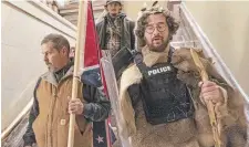  ?? MANUEL BALCE CENETA
THE ASSOCIATED PRESS FILE PHOTO ?? Supporters of president Donald Trump, including Aaron Mostofsky, right, walk down the stairs outside the Senate Chamber in the U.S. Capitol on Jan. 6, 2021.