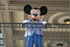  ?? TED SHAFFREY, FILE — THE ASSOCIATED PRESS ?? An actor dressed as Mickey Mouse greets visitors at the entrance to Magic Kingdom Park at Walt Disney World Resort, April 18, 2022, in Lake Buena Vista, Fla.