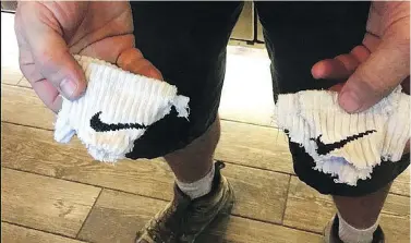  ?? JOHN RICH ?? In a photo posted on Twitter, country star John Rich showed off a pair of Nike logos that had been removed from his soundman’s socks in response to Nike making Colin Kaepernick a face of its 30th anniversar­y ad campaign.