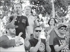  ?? Photograph­s by Irfan Khan Los Angeles Times ?? COUNCILMAN Randy Fox, back, Mayor Karen Spiegel and Jeremy Mercer, bottom left, clap as Corona Life Services’ Buzz Brown speaks at March for Life event.